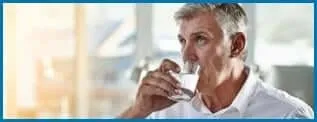 Man taking Nerve Fresh supplement with water